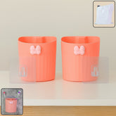 Wall-mounted toothbrush holder with butterfly design holding toothbrushes