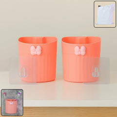 Wall-mounted toothbrush holder with butterfly design holding toothbrushes