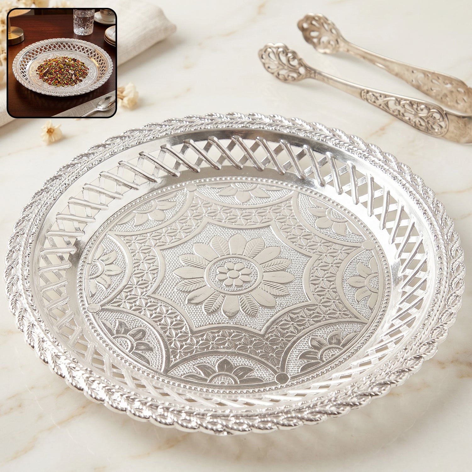 Elegant silver round serving tray with embossed floral design and lattice border