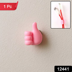 Pink thumb hook cable holder mounted on a surface