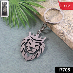 Stylish metal lion head keychain with crown on wooden surface