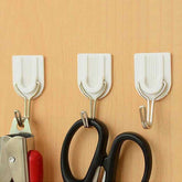 White self-adhesive wall hook for towels and robes.