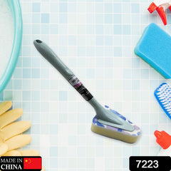 Person cleaning a bathroom tub with a long handle triangular brush