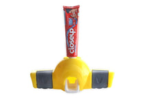 Inside view of automatic toothpaste dispenser showing vacuum pump mechanism