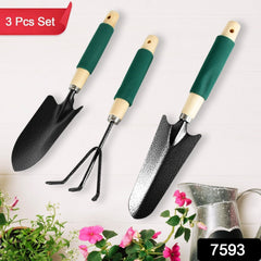 Close-up of the gardening tools showing wooden handles and steel heads