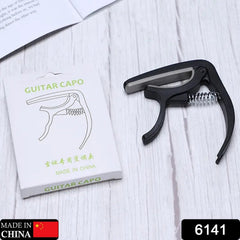 Close-up of guitar capo showing memory spring tension