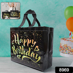Black birthday gift bag with golden stars angled view