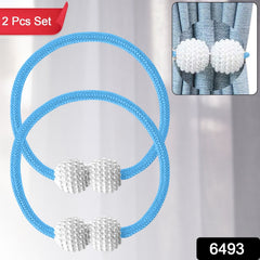 Close-up of magnetic curtain tieback holding a sheer curtain