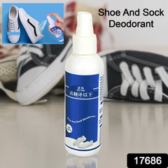 Spray bottle with deodorizer misting over sports shoes