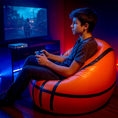 Happy child sitting comfortably in the portable inflatable ball chair, enjoying leisure time.