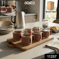 Set of six ceramic tea cups with handles arranged neatly