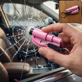 A hand holds a pink emergency tool, breaking a car window with a spiderweb crack pattern; a small inset shows the tool on