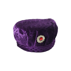 Boy wearing velvet traditional cap with stone brooch