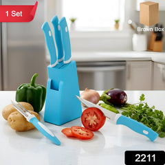 Close-up of stainless steel knives and peeler in stand