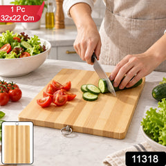 A person's hands are visible, slicing a cucumber on a bamboo cutting board, with various vegetables around.