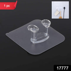 Close-up of transparent self-adhesive hook holding towel