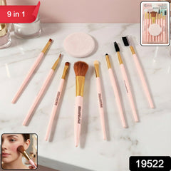 Assorted makeup brushes and face puff on a white background
