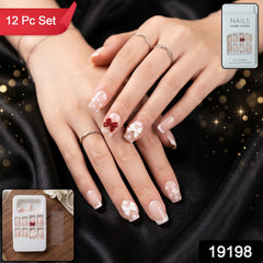 The complete set of 26 artificial nail tips with glitter and floral embellishments, neatly arranged in their packaging.