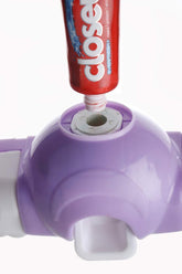 Automatic toothpaste dispenser with integrated 4-slot toothbrush holder