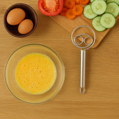 Stainless steel whisk in hand