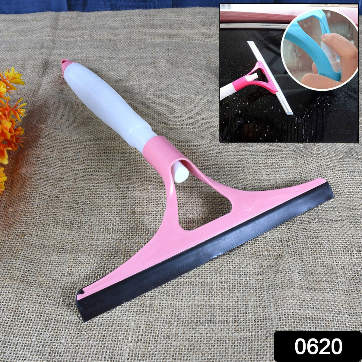 Person using the cleaning brush with spray bottle on a glass surface