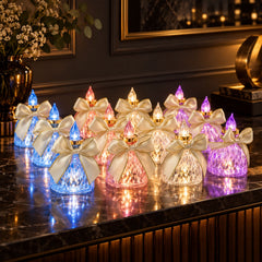 Twelve faceted LED candles with cream bows and gold trim glow in blue, pink, and purple hues on a dark marble surface.