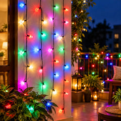 Colorful LED string lights glow on a wall and balcony railing at dusk, enhancing the outdoor decor with a warm ambiance.