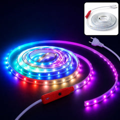 A coiled multicolor LED light strip with a red inline control switch, illuminating a dark room.