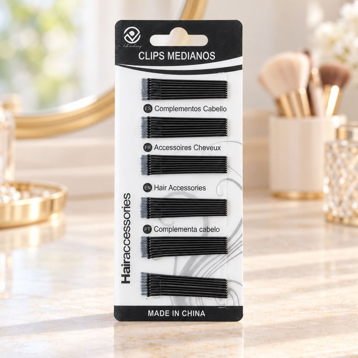 A black and white package of U-shaped hair pins sits on a vanity with a mirror and makeup brushes.