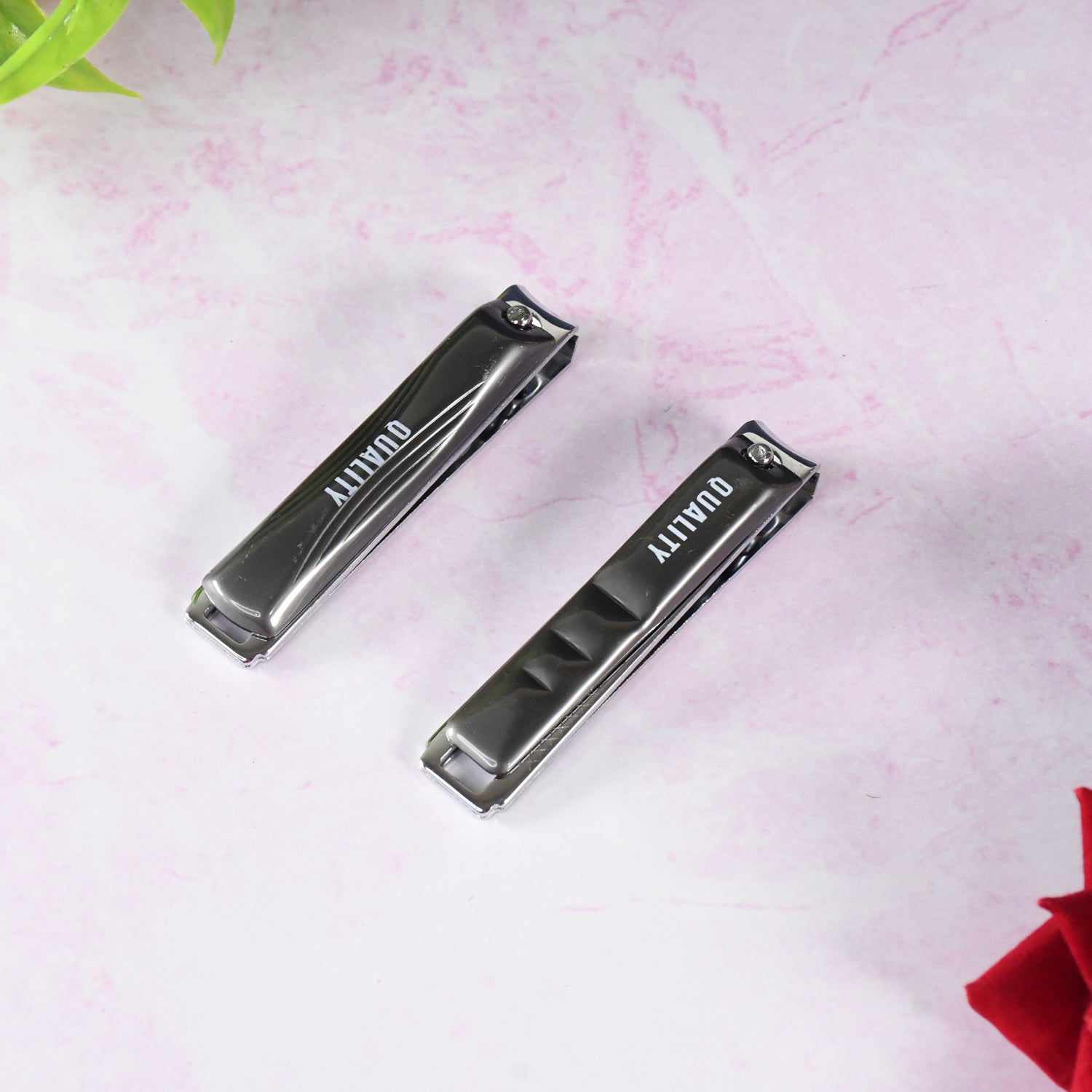 Nail clipper cutting fingernail with sharp blades