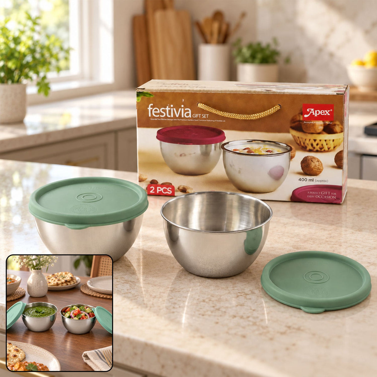 Two stainless steel bowls with green lids, one open, one closed, on a kitchen counter with product packaging.