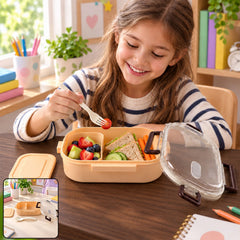 A girl smiles while eating fruit from a peach lunchbox, filled with a diverse meal of fruit, sandwiches, and vegetables.