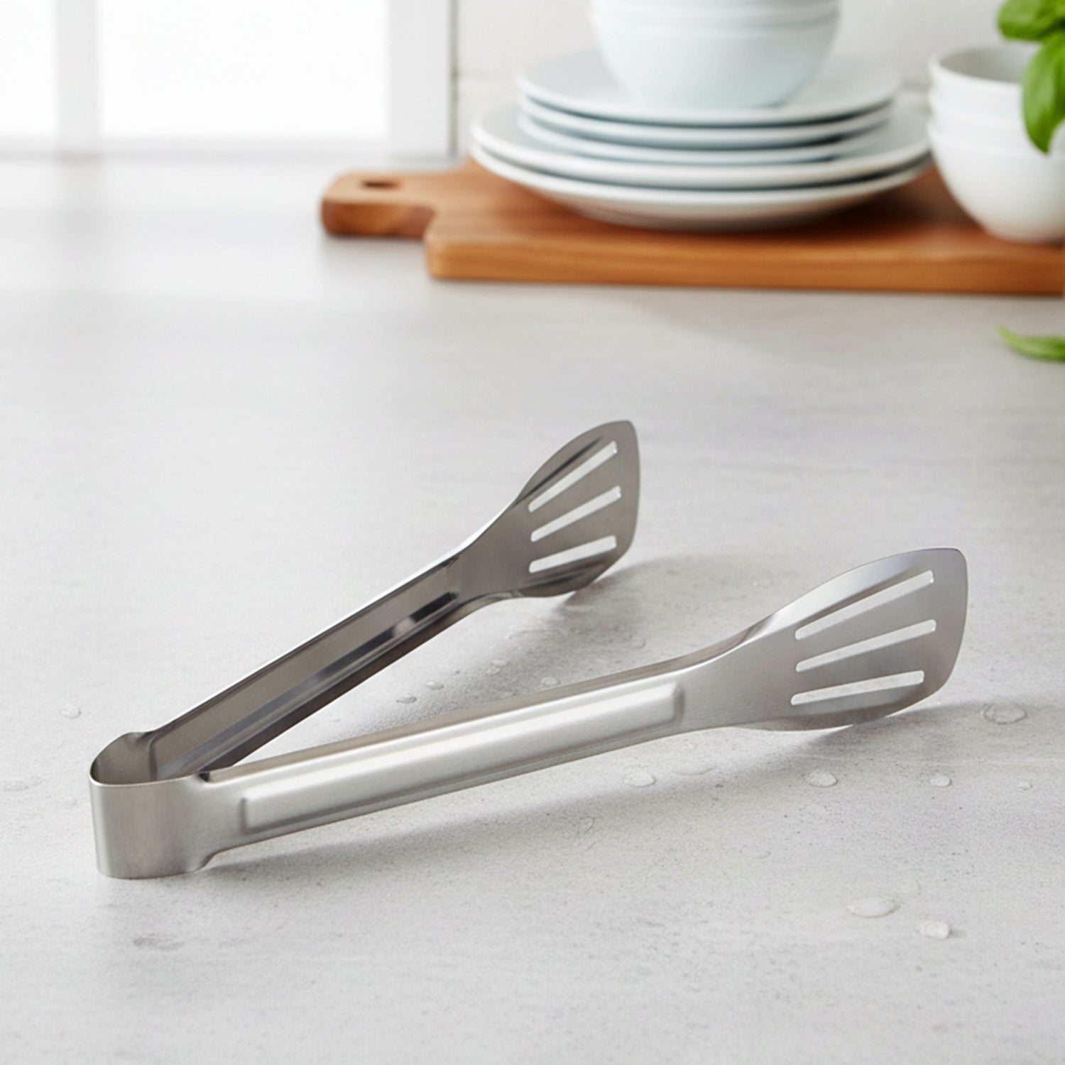 Serving tongs next to plates