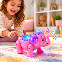 A happy child reaches towards a pink elephant toy with blue ears and sparkling lights on a colorful rug.