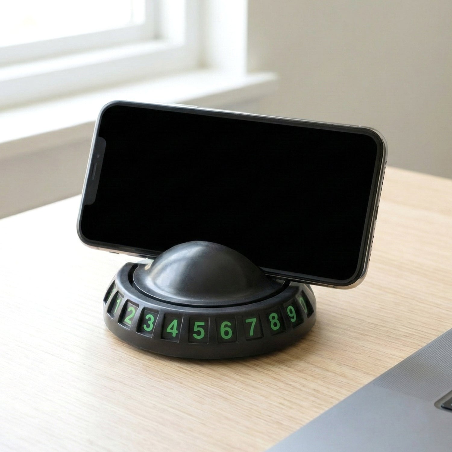 Close-up of the dashboard mobile holder showing the anti-slip base and parking number display.