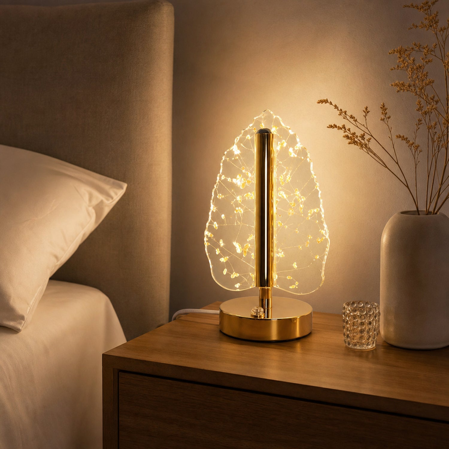 Bedside setup with golden crystal leaf-shaped LED lamp