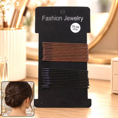 A black card holds brown and black bobby pins, with an inset of a woman's dark hair styled in a neat bun.