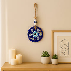 Close-up of the blue evil eye wall hanging with beads and jute rope