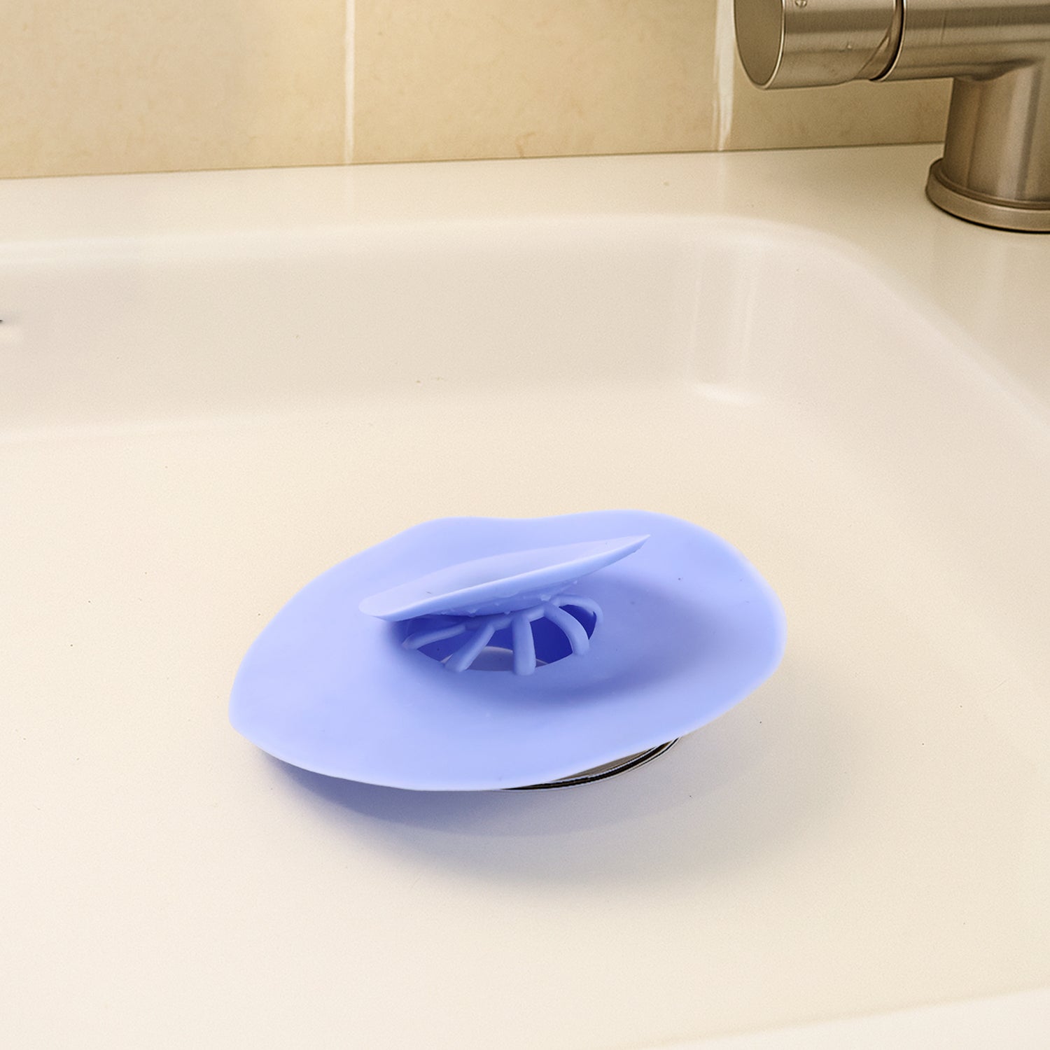 Blue silicone sink drain strainer on white background