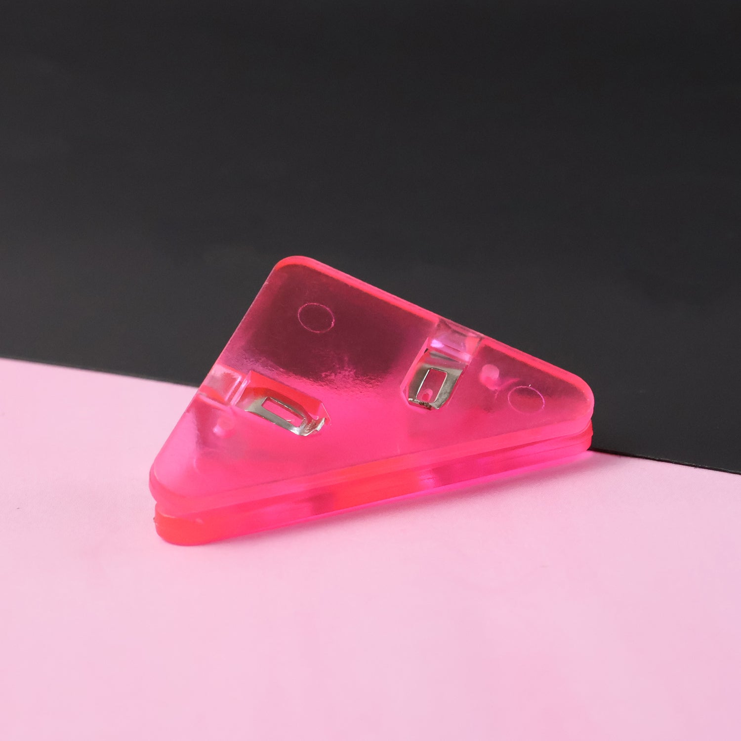 Triangle paper clip on paper corner