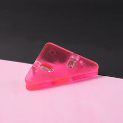 Triangle paper clip on paper corner