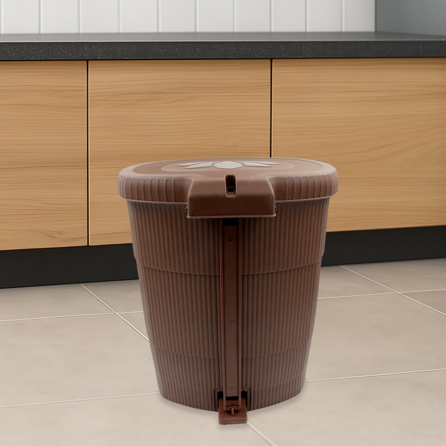 Mini plastic pedal dustbin, side view, showing pedal