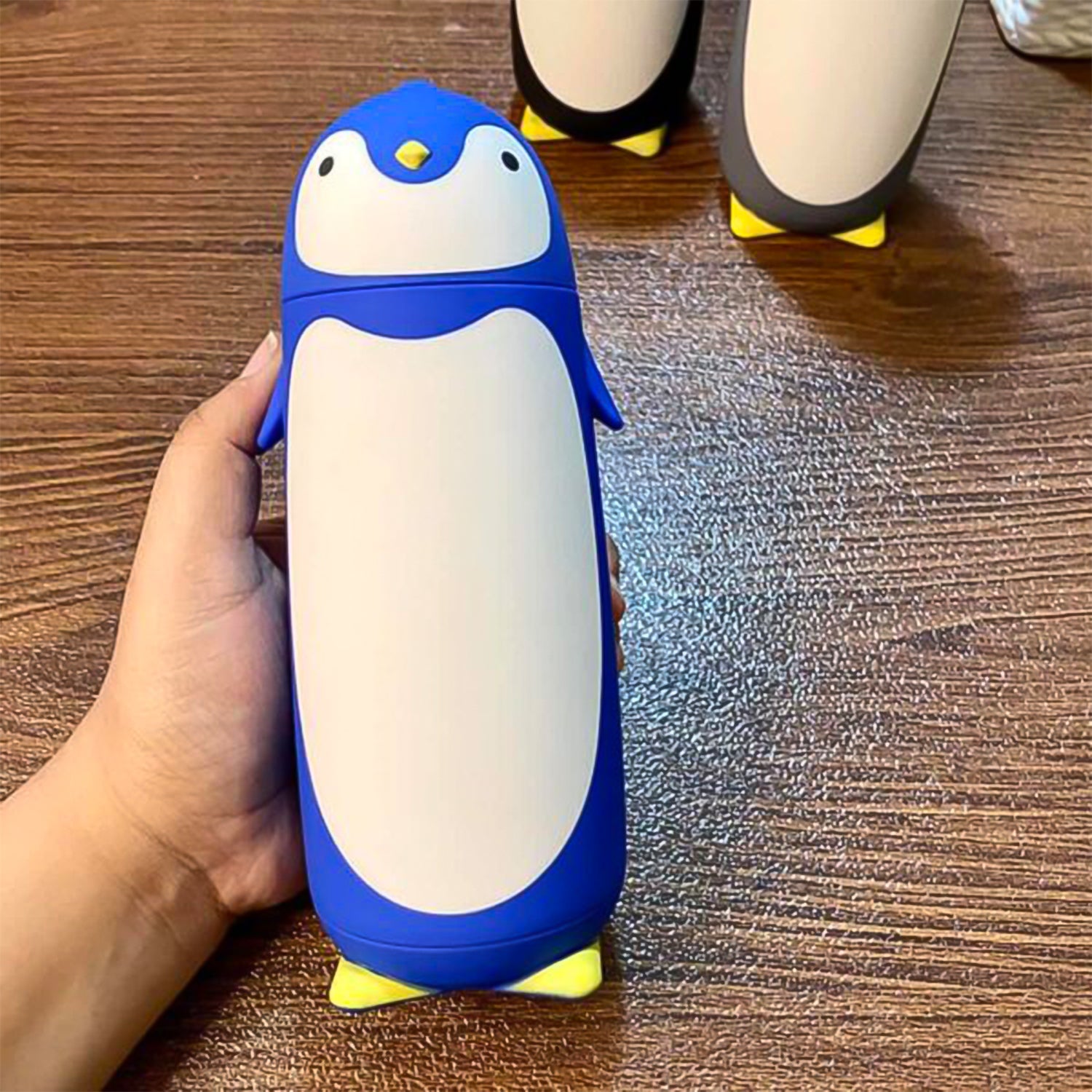 Blue & black penguin cartoon water bottle, side view
