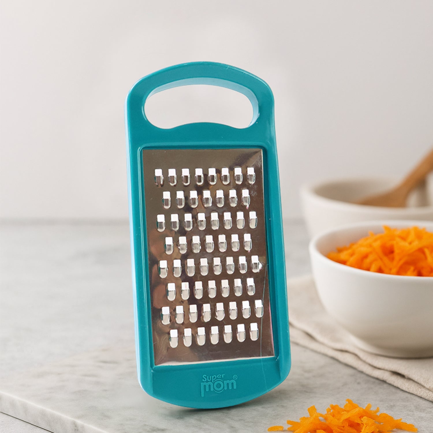 Side angle showing sharp stainless steel blade of Supermom grater