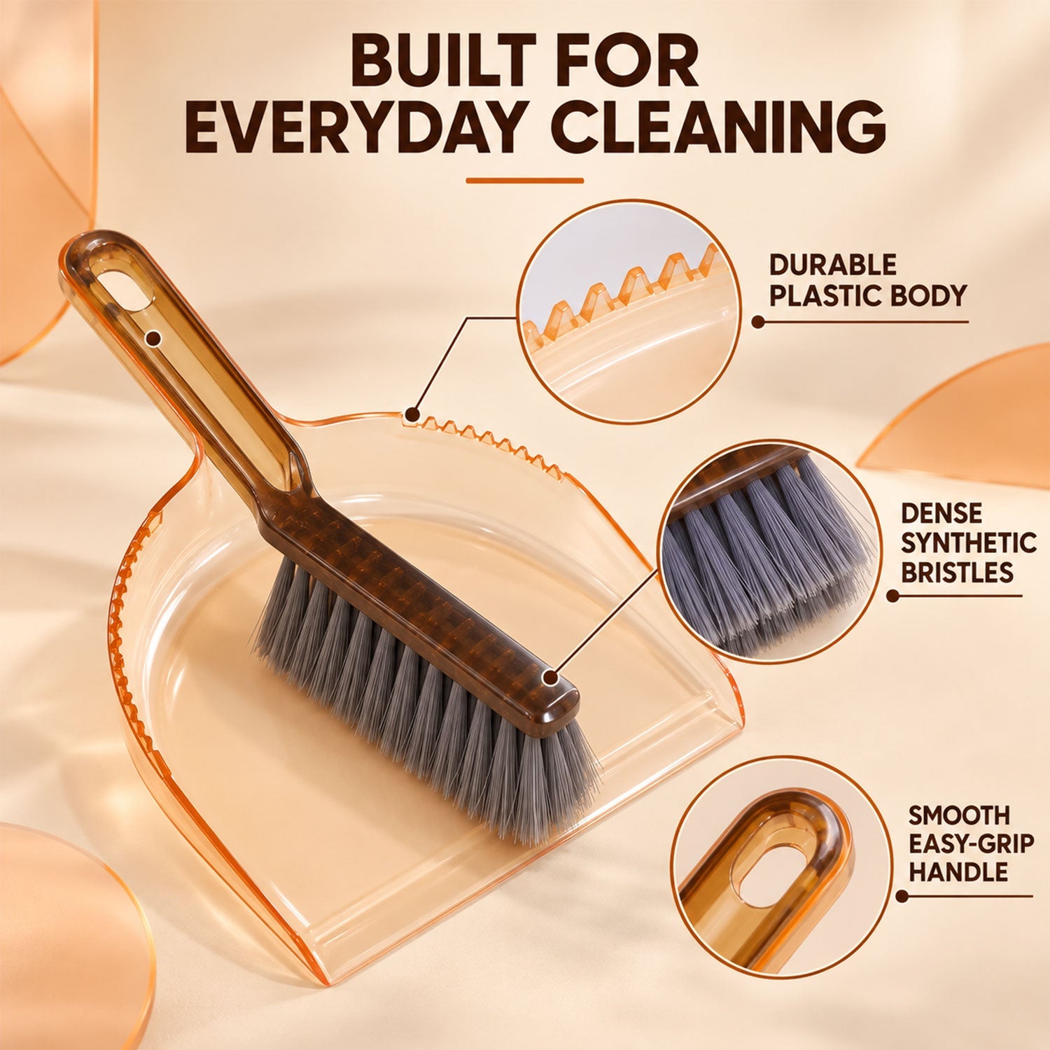 An amber plastic dustpan and dark brown brush with gray bristles are displayed with callouts for features like durable body