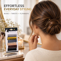 A woman with brown hair has a gold hairpin in a bun, with a package of hairpins on a vanity.