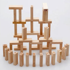 Person removing block from wooden tumbling tower game