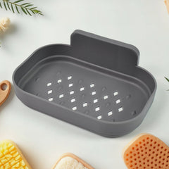 Plastic soap holder attached to tile surface