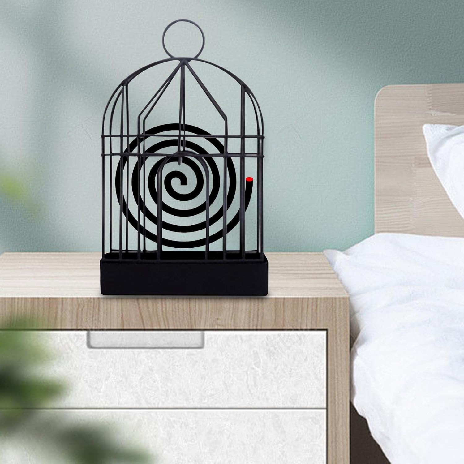 Mosquito coil holder displayed outdoors on summer evening table