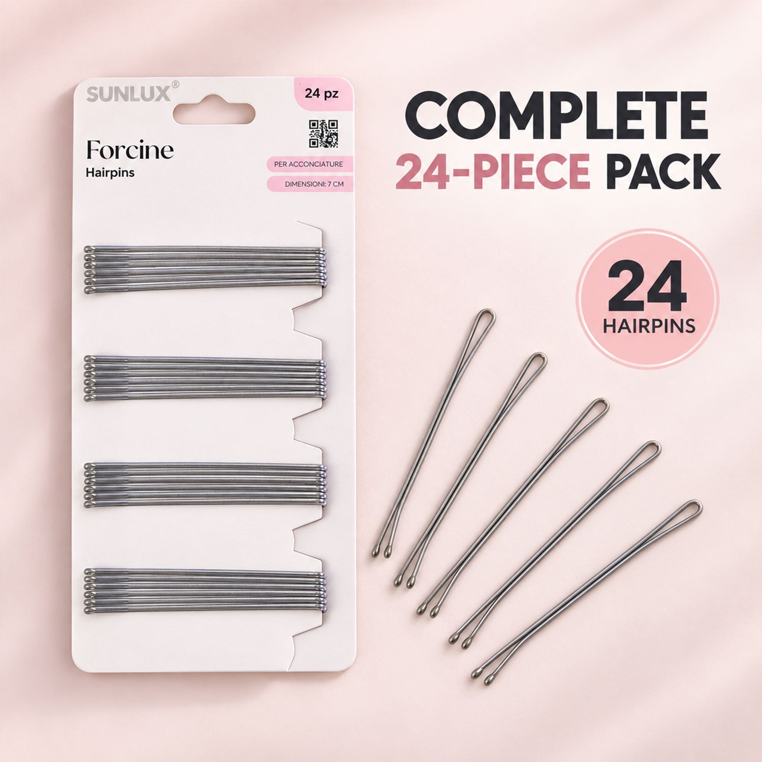 A white package of twenty-four silver hairpins next to five loose hairpins on a light pink surface.